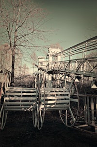 a wooden bridge with a wooden bench in front of it