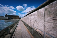 a concrete wall with a railing