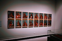 a group of paintings on display in a museum