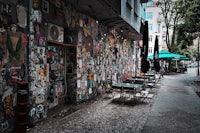 a sidewalk with tables and chairs