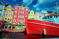 a red boat docked in a harbor