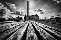 a black and white photo of a wooden walkway