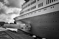 a large cruise ship docked at a dock