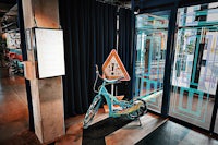 a blue bicycle in front of a door