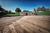 a person walking on a wooden bridge