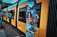 a yellow train on a city street