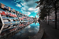 a building is reflected in a body of water