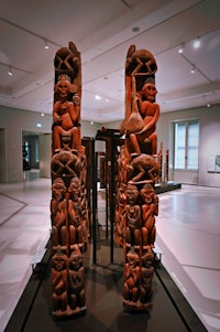 a group of carved statues in a museum