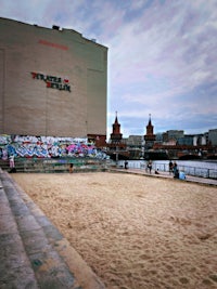 a sand volleyball court in front of a building