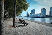 a row of benches next to a river