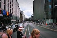 a group of people walking down a city street