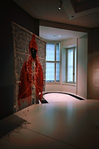 a red cloak hanging on a wall in a room