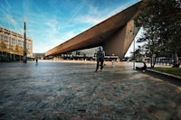 a person is riding a skateboard in front of a building