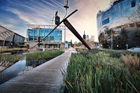 a wooden walkway next to a building