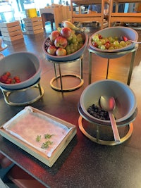 a table with bowls of fruit on it