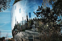 a large building is reflected in the sky