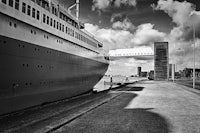 a large cruise ship docked at a dock