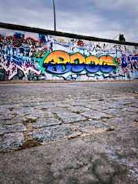 a person riding a skateboard on a graffiti covered wall