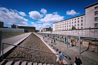 a group of people walking down a stairway in front of a building